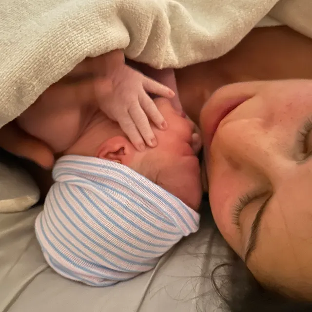 A parent cradles a newborn after birth.
