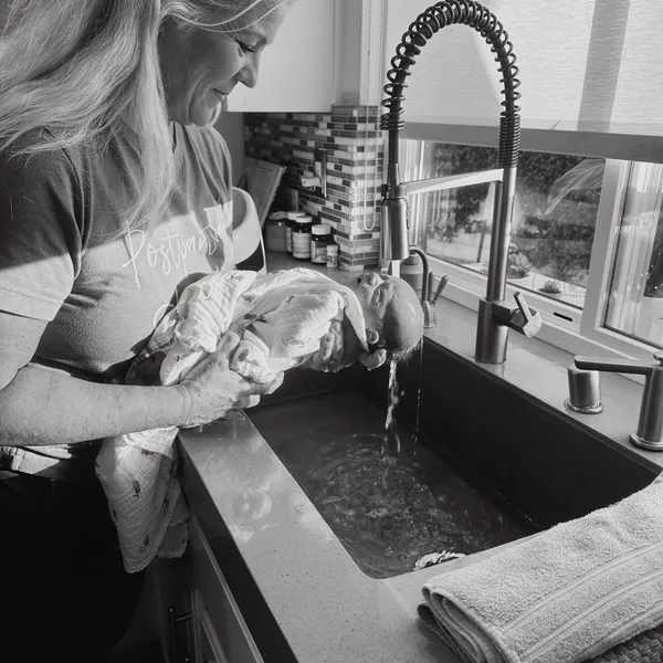 Teesee Logan caring for a newborn at home.