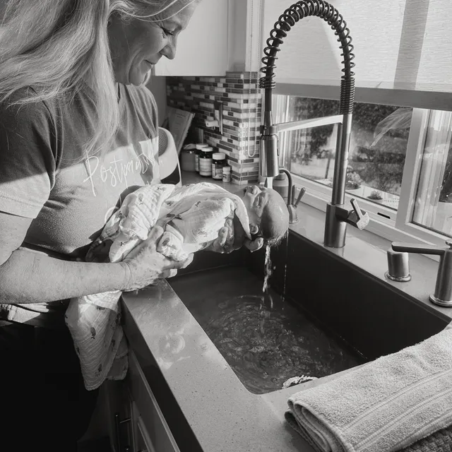 Teesee Logan caring for a newborn at home.